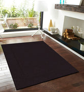 Solid dark brown wool rug for rustic and modern interiors